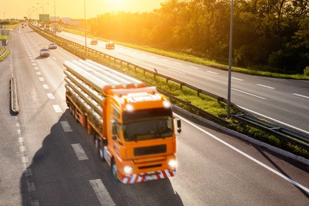 Orange truck on highway